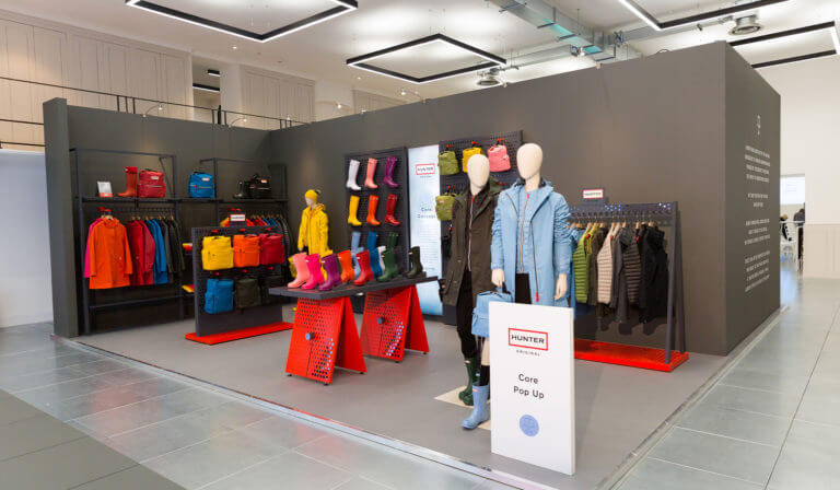 shop display for hunter boots event including wellington boots raincoats and bags