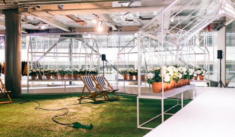 hunter boots event with greenhouses extending over a catwalk and fake grass